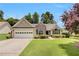 Charming single-Gathering home with a well-manicured lawn and attached two-car garage at 2145 Charleston Oak Cir, Lawrenceville, GA 30043