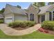 Beautiful home with mature landscaping, arched windows, and a well-maintained lawn at 2145 Charleston Oak Cir, Lawrenceville, GA 30043