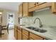 Well-lit kitchen featuring granite countertops, wooden cabinets, stainless steel faucet, and modern appliances at 2145 Charleston Oak Cir, Lawrenceville, GA 30043