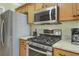 Close-up of a modern gas range and stainless steel appliances in a well-lit kitchen at 2145 Charleston Oak Cir, Lawrenceville, GA 30043