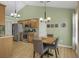 Eat-in kitchen area with stainless steel appliances, wooden cabinets and hardwood floors at 2145 Charleston Oak Cir, Lawrenceville, GA 30043