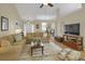 Open living room with hardwood floors, comfortable seating, and a seamless flow to the dining area at 2145 Charleston Oak Cir, Lawrenceville, GA 30043