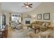 Cozy living room features a fireplace, comfortable seating, and a view of the backyard at 2145 Charleston Oak Cir, Lawrenceville, GA 30043