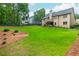 Expansive backyard with well-maintained lawn, mature trees, and a black fence, enhancing the property's appeal at 516 Black Horse Cir, Canton, GA 30114