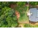 Aerial view showcases the large backyard with mature trees and landscaped areas, ideal for outdoor activities and relaxation at 516 Black Horse Cir, Canton, GA 30114