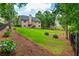 Large grassy backyard with landscaping and a black fence providing a private outdoor space for enjoyment at 516 Black Horse Cir, Canton, GA 30114
