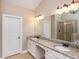 This bright primary bath has granite counters, double sinks and custom cabinets at 516 Black Horse Cir, Canton, GA 30114