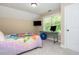 Cozy bedroom with a colorful quilt, workspace setup with a desk, computer, TV, and bright natural light at 516 Black Horse Cir, Canton, GA 30114