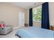 Bedroom with carpet, large window, and blue curtains at 516 Black Horse Cir, Canton, GA 30114