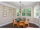 Charming breakfast nook featuring large windows, a hanging chandelier, and view of the exterior at 516 Black Horse Cir, Canton, GA 30114
