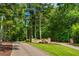 Stone entrance with decorative water feature and lush greenery on a private drive at 516 Black Horse Cir, Canton, GA 30114