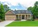 Charming single-Gathering home with manicured lawn, covered porch, and attached two-car garage at 516 Black Horse Cir, Canton, GA 30114