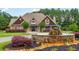 Traditional home featuring stone water fountain in circular drive, dormer windows, and manicured landscaping at 516 Black Horse Cir, Canton, GA 30114