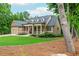 Beautifully landscaped front yard of a single-Gathering home with covered porch and attached garage at 516 Black Horse Cir, Canton, GA 30114