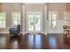 Entryway featuring dark wood flooring, white trim, and large windows providing lots of natural light at 516 Black Horse Cir, Canton, GA 30114