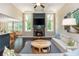 Bright living room with fireplace, large windows, and an open layout to the dining area at 516 Black Horse Cir, Canton, GA 30114