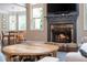 Cozy living room featuring a fireplace, natural light, and an adjacent breakfast area at 516 Black Horse Cir, Canton, GA 30114