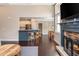 Open-concept living space with a cozy fireplace and view of the adjacent kitchen and dining area at 516 Black Horse Cir, Canton, GA 30114
