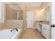 This primary bathroom features a soaking tub, separate shower and double vanity at 516 Black Horse Cir, Canton, GA 30114