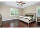 Spacious main bedroom with a trey ceiling, hardwood floors, and natural light from a window at 516 Black Horse Cir, Canton, GA 30114