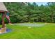 Lush backyard putting green with multiple holes and an American flag waving nearby at 516 Black Horse Cir, Canton, GA 30114