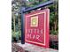 The community entrance sign with the name 'Little Bear' on a maroon and gold background at 516 Black Horse Cir, Canton, GA 30114