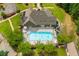Aerial view of a community pool surrounded by trees and lounge chairs on a sunny day at 516 Black Horse Cir, Canton, GA 30114