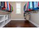 This is a walk-in closet with hardwood floors and custom shelving at 516 Black Horse Cir, Canton, GA 30114