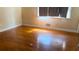 Bedroom featuring wood floors, a window, and white trim at 6521 Menlo Way, Rex, GA 30273