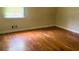 Bedroom featuring hardwood floors and a window providing natural light and ventilation at 6521 Menlo Way, Rex, GA 30273