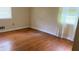This bedroom is equipped with hardwood floors and a window providing natural light at 6521 Menlo Way, Rex, GA 30273