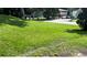 Street view of the front yard, showcasing the green space in the neighborhood at 6521 Menlo Way, Rex, GA 30273