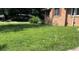 View of the front yard, showing the lawn and the side of the home at 6521 Menlo Way, Rex, GA 30273