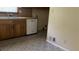 The kitchen features durable tile flooring and essential appliances, ready for culinary adventures at 6521 Menlo Way, Rex, GA 30273