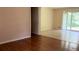 Living room showing hardwood floors, a doorway, and sliding glass door to backyard at 6521 Menlo Way, Rex, GA 30273