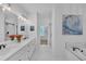 Elegant bathroom with double vanity sinks, large mirror, and a soaking tub, perfect for relaxation at 104 Woodland Ln, Canton, GA 30114