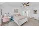 Bright bedroom boasts a ceiling fan, white walls, and plush carpeting for a cozy and inviting atmosphere at 104 Woodland Ln, Canton, GA 30114