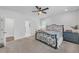 Bright bedroom with a stylish wrought iron bed frame, ceiling fan, and neutral tones creating a relaxing atmosphere at 104 Woodland Ln, Canton, GA 30114