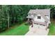 Charming two-story home with a two car garage, a cozy front porch and a lush, landscaped yard surrounded by mature trees at 104 Woodland Ln, Canton, GA 30114