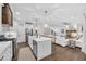 Open kitchen and living area with white cabinetry, an island with bar seating, and hardwood floors at 104 Woodland Ln, Canton, GA 30114