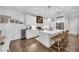 Bright kitchen with white cabinets, a center island, and hardwood floors at 104 Woodland Ln, Canton, GA 30114