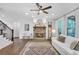 Open living space with a stone fireplace, hardwood floors, and staircase at 104 Woodland Ln, Canton, GA 30114