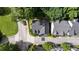 Aerial view of a home featuring a dark gray roof, driveway, mature trees, and surrounding streetscape at 1360 Edmund Ne Ct, Atlanta, GA 30306