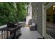 Back deck with grill and seating offers outdoor living space surrounded by trees, perfect for relaxing or entertaining guests at 1360 Edmund Ne Ct, Atlanta, GA 30306