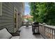 Outdoor deck with a grill, dining set, and comfortable seating, perfect for entertaining and enjoying the surrounding greenery at 1360 Edmund Ne Ct, Atlanta, GA 30306
