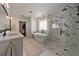 Bathroom featuring double sinks, a soaking tub, a frameless shower, and marble accents at 1360 Edmund Ne Ct, Atlanta, GA 30306