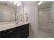 Bright bathroom features a sleek vanity with a black cabinet, a large mirror, and white walls for a clean, modern feel at 1360 Edmund Ne Ct, Atlanta, GA 30306