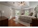 Inviting bedroom with hardwood floors, tray ceiling, and French doors leading to an outdoor space at 1360 Edmund Ne Ct, Atlanta, GA 30306