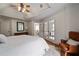 Primary bedroom featuring hardwood floors, tray ceiling, and French doors that lead to an en-suite bathroom at 1360 Edmund Ne Ct, Atlanta, GA 30306