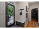 Cozy entryway with a bench, coat hooks, and a view of the outdoor deck, blending indoor and outdoor living seamlessly at 1360 Edmund Ne Ct, Atlanta, GA 30306